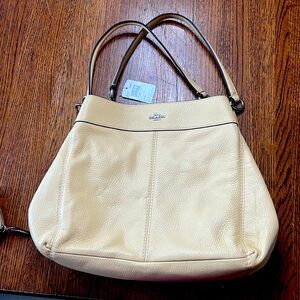 Pale Yellow Coach Purse. Brand New and in perfect condition.